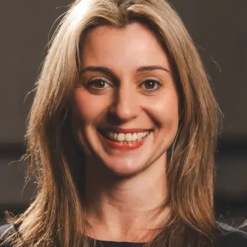 Smiling woman with long blonde hair facing the camera (headshot).